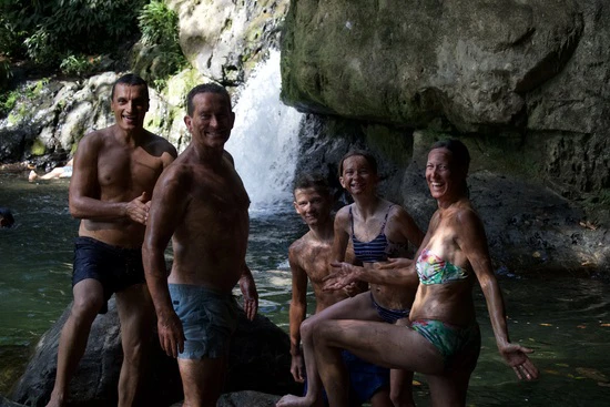 Family laughing by waterfalls