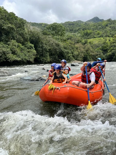 Happy family in a raft on the rapids of the Santo Domingo River