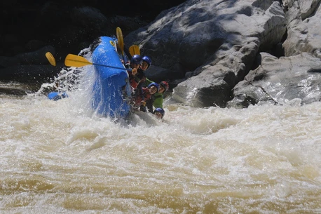 Raft flipping in a rapid on the Calderas river in Colombia