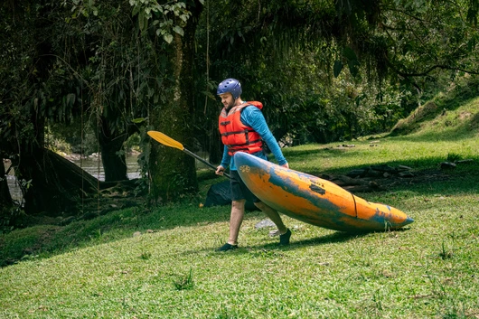 Kayaker carrying his kayak to the river