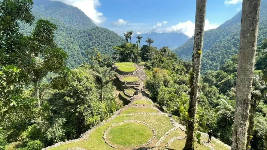 Front view of the lost city with palm trees and mountain range in the background